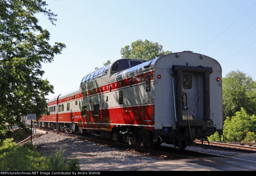 Two red and gray Northern Sky Charters cars on the tail of No. 7 today